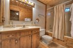 Loft master bathroom ith a tub shower combo 